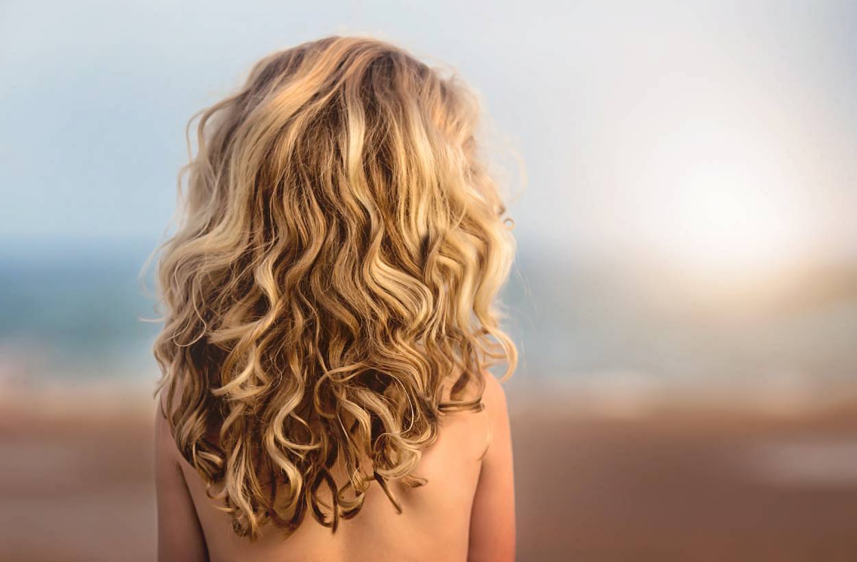 Woman with blond curly hair